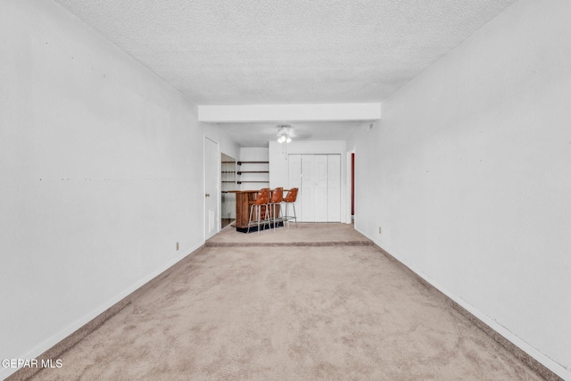 8763 Cathedral Cir, El Paso, TX 79907 - spare room with a dry bar, a textured ceiling, and carpet floors