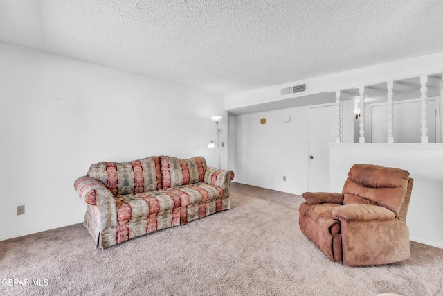 8763 Cathedral Cir, El Paso, TX 79907 - carpeted living area featuring a textured ceiling