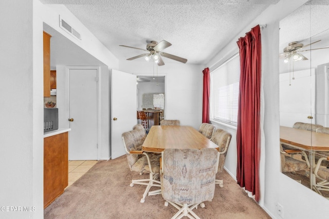 8763 Cathedral Cir, El Paso, TX 79907 - dining space featuring a ceiling fan, a textured ceiling, light tile patterned floors, and light colored carpet