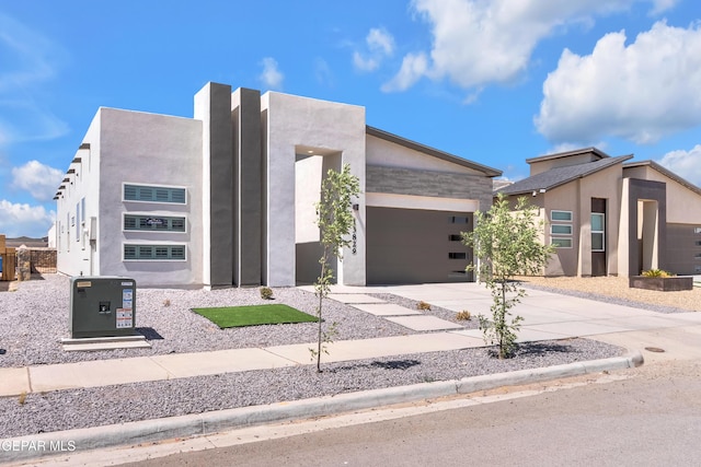 13829 Summer View Ave, Horizon City, TX 79928 - contemporary house with driveway, a garage, and stucco siding