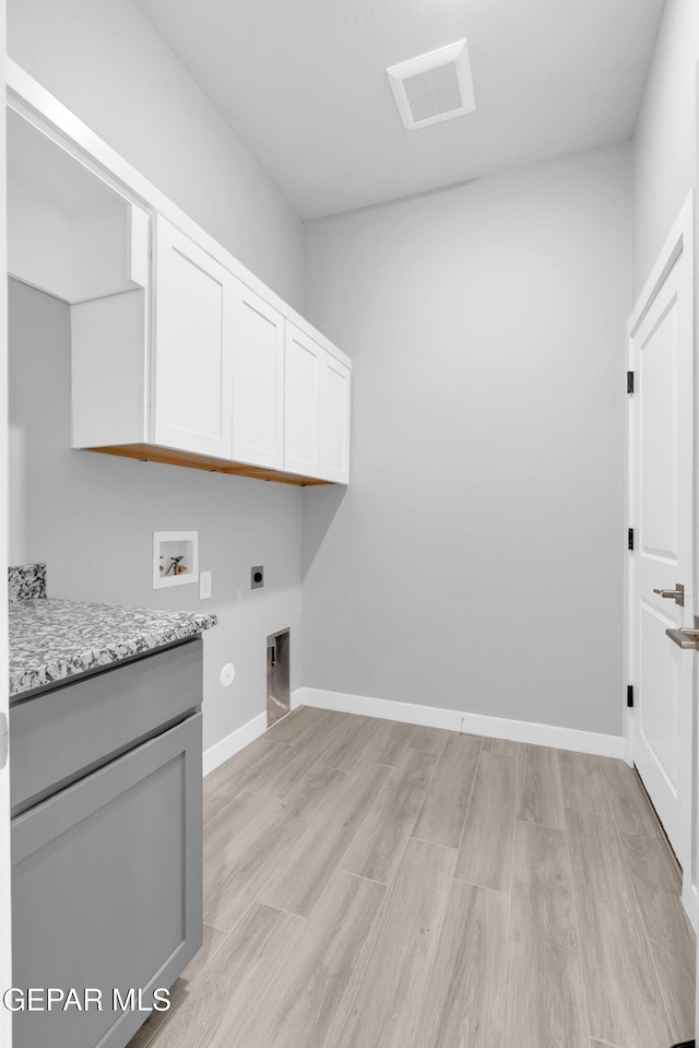 13829 Summer View Ave, Horizon City, TX 79928 - laundry room with electric dryer hookup, cabinet space, light wood-style floors, and washer hookup