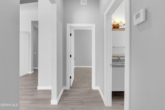 13829 Summer View Ave, Horizon City, TX 79928 - corridor featuring light wood-style flooring and a sink