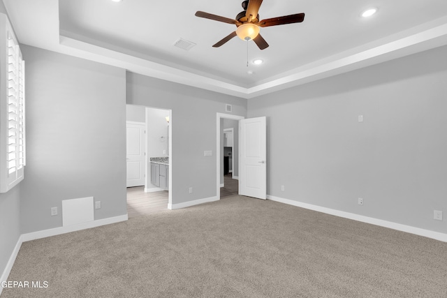 13829 Summer View Ave, Horizon City, TX 79928 - unfurnished bedroom featuring a raised ceiling, carpet flooring, recessed lighting, and ensuite bath