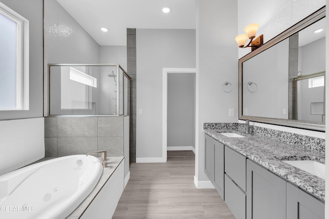 13829 Summer View Ave, Horizon City, TX 79928 - full bathroom with a shower stall, a whirlpool tub, double vanity, wood finished floors, and recessed lighting
