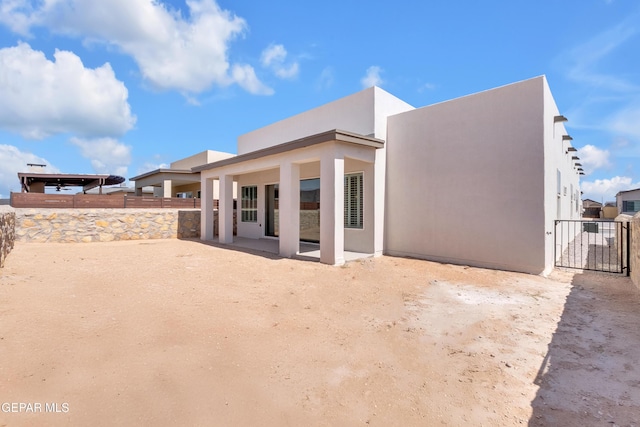 13829 Summer View Ave, Horizon City, TX 79928 - back of house with stucco siding, a patio, and a gate