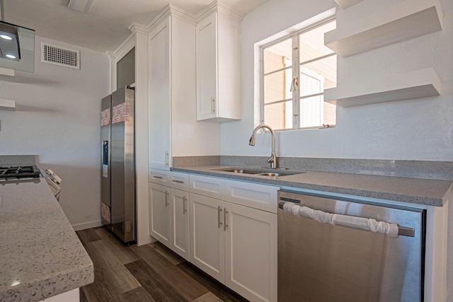 1400 Elmhurst Dr, El Paso, TX 79925 - kitchen with appliances with stainless steel finishes, white cabinetry, open shelves, dark wood finished floors, and light stone countertops