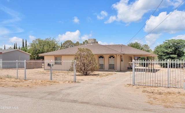 view of front of property featuring driveway and a carport