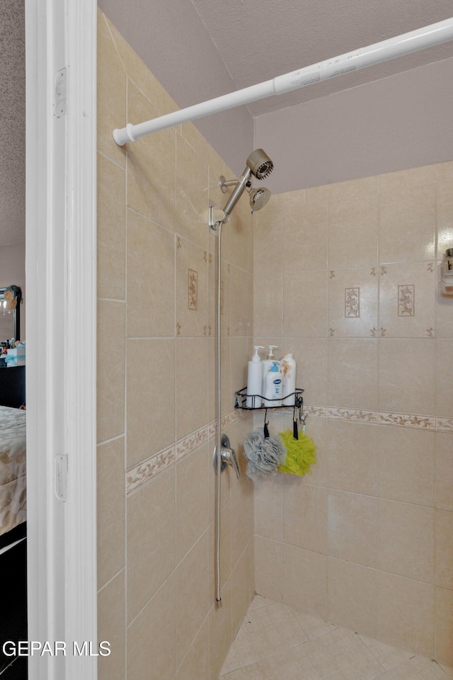bathroom with tiled shower