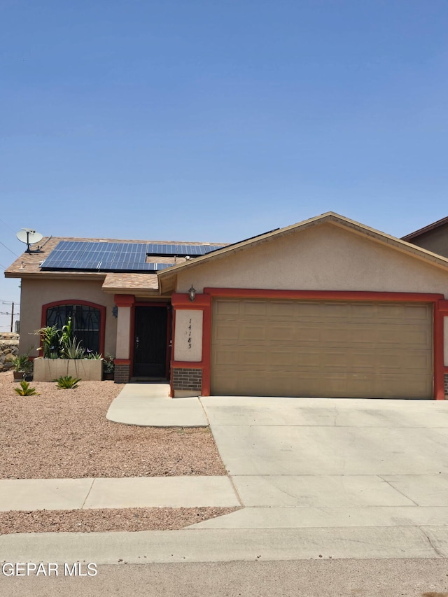 14185 Silver Point Ave, El Paso, TX 79938 - single story home with an attached garage, stucco siding, concrete driveway, and solar panels
