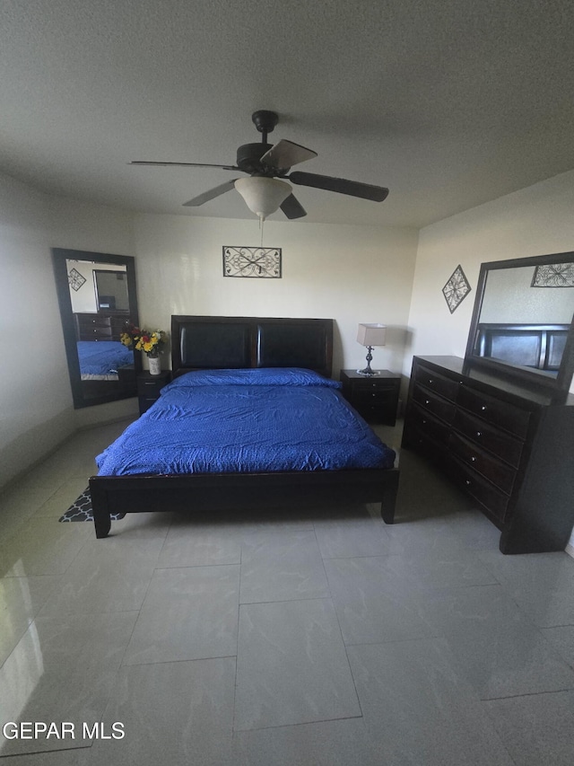 14185 Silver Point Ave, El Paso, TX 79938 - tiled bedroom featuring ceiling fan and a textured ceiling