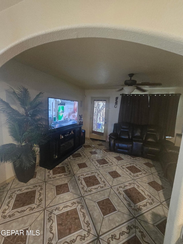 14185 Silver Point Ave, El Paso, TX 79938 - tiled living area with arched walkways and ceiling fan