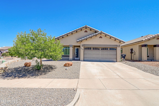 12469 Lanchester Dr, El Paso, TX 79928 - mediterranean / spanish house with an attached garage, stucco siding, driveway, and a tiled roof