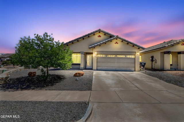 12469 Lanchester Dr, El Paso, TX 79928 - mediterranean / spanish-style house with driveway, an attached garage, stucco siding, and a tiled roof