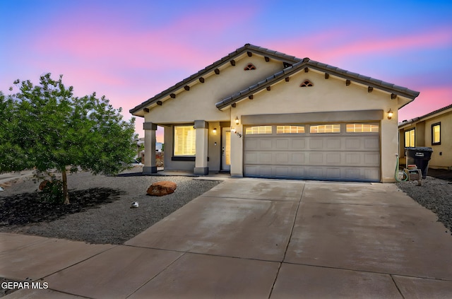 12469 Lanchester Dr, El Paso, TX 79928 - mediterranean / spanish-style home with concrete driveway, stucco siding, and an attached garage