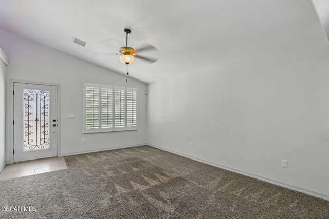 12469 Lanchester Dr, El Paso, TX 79928 - empty room featuring ceiling fan, vaulted ceiling, carpet floors, and tile patterned flooring