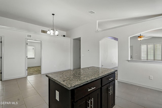 12469 Lanchester Dr, El Paso, TX 79928 - kitchen featuring arched walkways, healthy amount of natural light, and light tile patterned floors