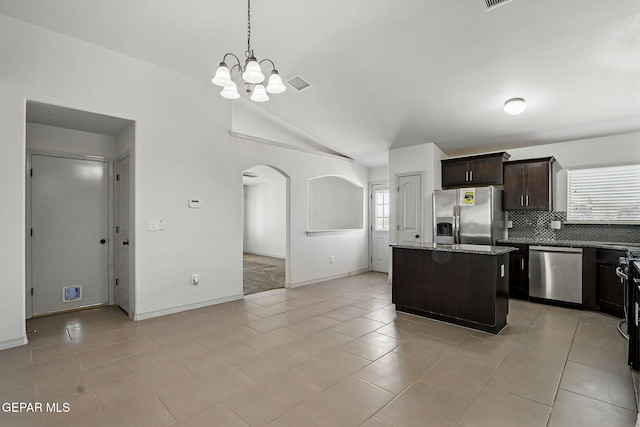 12469 Lanchester Dr, El Paso, TX 79928 - kitchen featuring stainless steel appliances, arched walkways, dark brown cabinetry, plenty of natural light, and high vaulted ceiling
