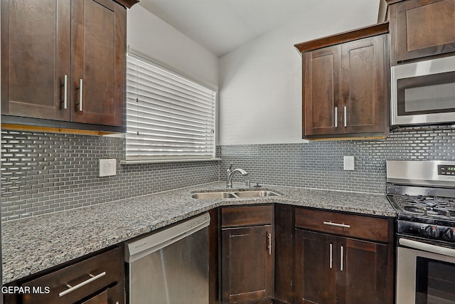 12469 Lanchester Dr, El Paso, TX 79928 - kitchen with appliances with stainless steel finishes, dark brown cabinetry, and light stone countertops