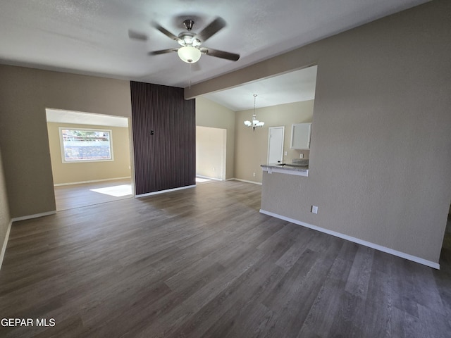1607 Gene Torres Dr, El Paso, TX 79936 - unfurnished living room featuring a ceiling fan, a chandelier, and dark wood-style flooring