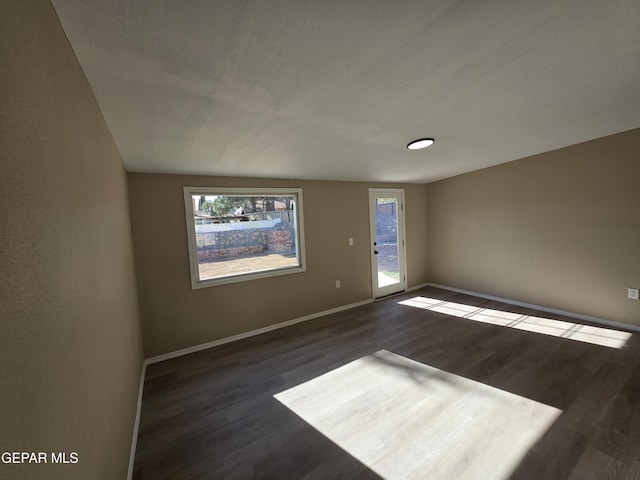 1607 Gene Torres Dr, El Paso, TX 79936 - unfurnished room featuring dark wood-type flooring and baseboards