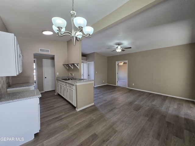 1607 Gene Torres Dr, El Paso, TX 79936 - kitchen featuring ceiling fan, white cabinets, dark wood-type flooring, a chandelier, and open floor plan