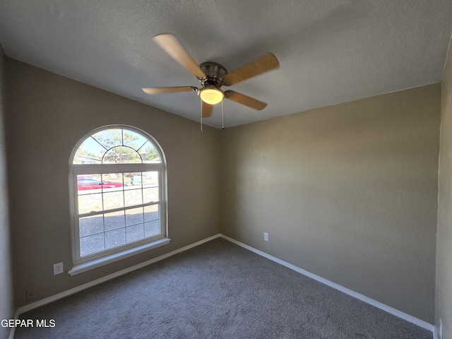 1607 Gene Torres Dr, El Paso, TX 79936 - unfurnished room featuring dark colored carpet, ceiling fan, and a textured ceiling