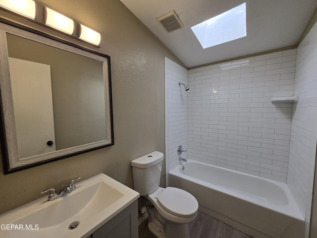 1607 Gene Torres Dr, El Paso, TX 79936 - full bath with a skylight, vaulted ceiling, vanity, wood finished floors, and bathing tub / shower combination