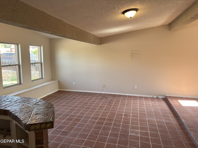 378 Hourglass Dr, El Paso, TX 79915 - empty room featuring a textured ceiling and tile patterned floors