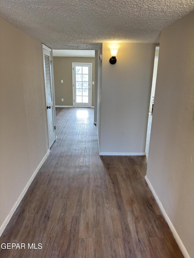 378 Hourglass Dr, El Paso, TX 79915 - hall featuring dark wood-style floors and a textured ceiling