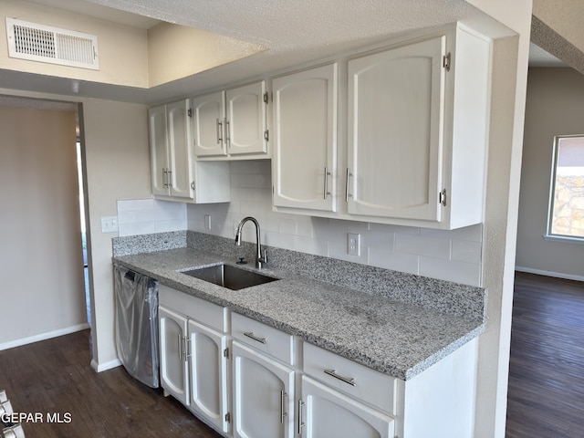 378 Hourglass Dr, El Paso, TX 79915 - kitchen featuring dark wood-style floors, tasteful backsplash, and white cabinets