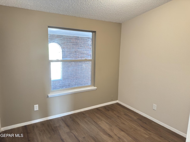 378 Hourglass Dr, El Paso, TX 79915 - unfurnished room featuring dark wood-type flooring and a textured ceiling