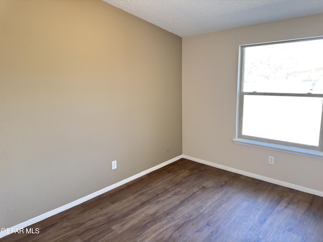 378 Hourglass Dr, El Paso, TX 79915 - spare room with dark wood-style flooring and a textured ceiling