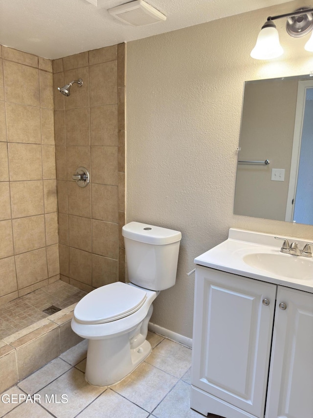 378 Hourglass Dr, El Paso, TX 79915 - full bathroom with vanity, tile patterned flooring, a tile shower, and a textured wall