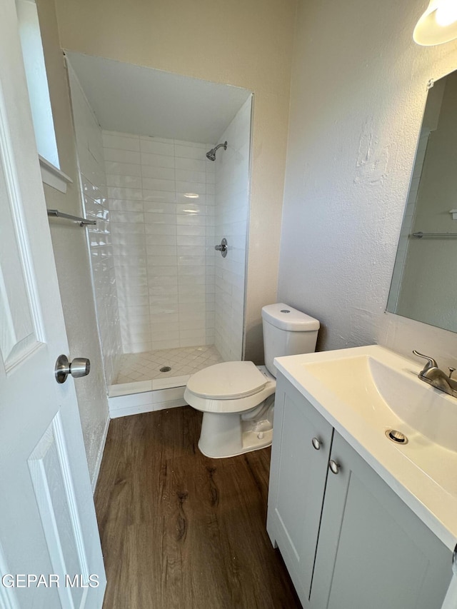 378 Hourglass Dr, El Paso, TX 79915 - full bath with wood finished floors, vanity, and a tile shower