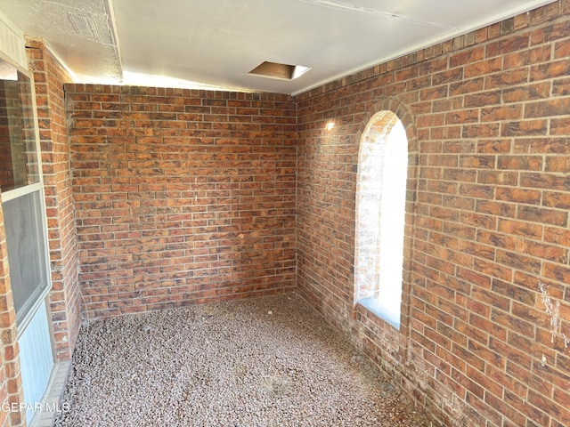378 Hourglass Dr, El Paso, TX 79915 - unfurnished room with brick wall