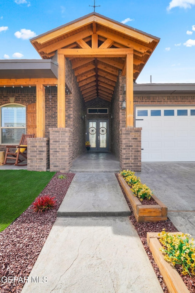 14516 Ciambriello Ave, El Paso, TX 79938 - entrance to property featuring french doors, a garage, concrete driveway, and brick siding