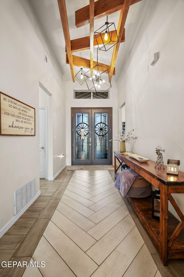 14516 Ciambriello Ave, El Paso, TX 79938 - foyer entrance featuring french doors, a high ceiling, a chandelier, beam ceiling, and tile patterned floors