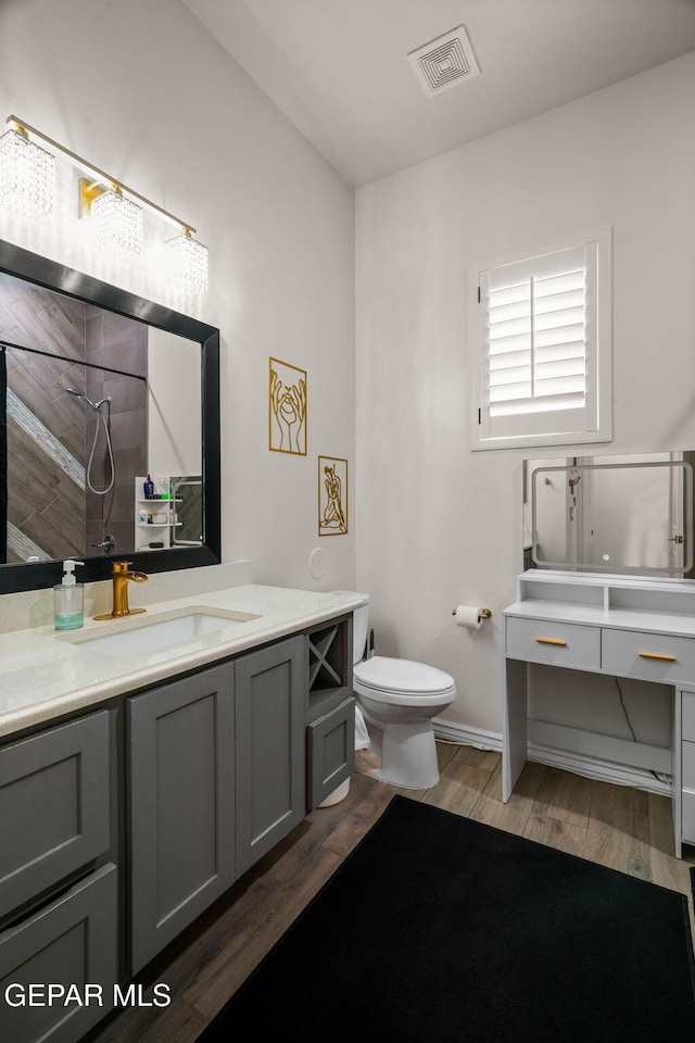 14516 Ciambriello Ave, El Paso, TX 79938 - bathroom featuring vanity, a tile shower, and wood finished floors