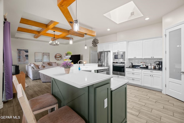 14516 Ciambriello Ave, El Paso, TX 79938 - kitchen with appliances with stainless steel finishes, coffered ceiling, light wood-style floors, beam ceiling, and white cabinetry