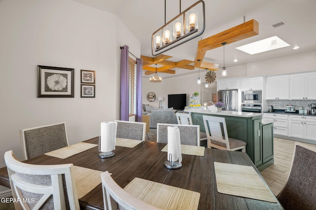 14516 Ciambriello Ave, El Paso, TX 79938 - dining area with coffered ceiling, beam ceiling, light wood-style floors, a skylight, and a chandelier