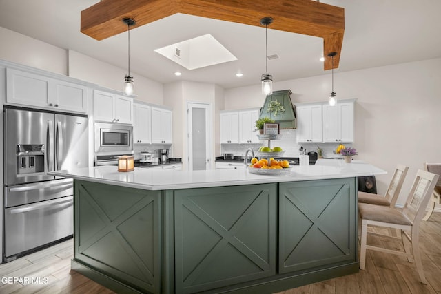 14516 Ciambriello Ave, El Paso, TX 79938 - kitchen featuring stainless steel appliances, green cabinets, white cabinets, a skylight, and recessed lighting