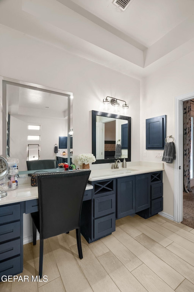 14516 Ciambriello Ave, El Paso, TX 79938 - full bathroom featuring a raised ceiling, wood finish floors, and vanity
