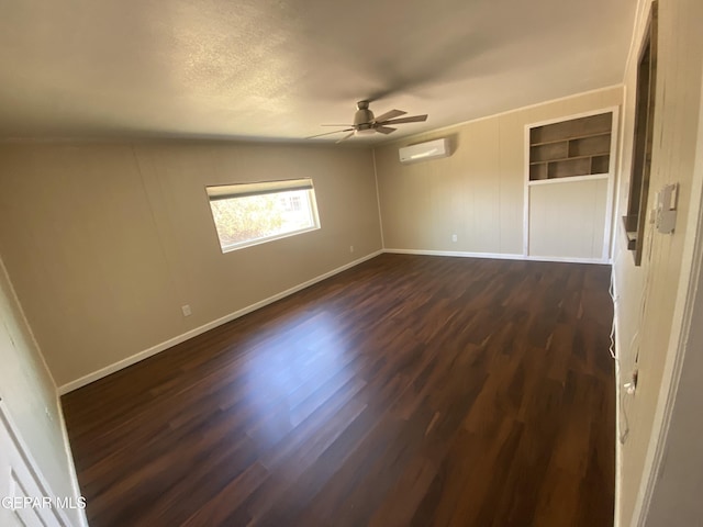 10356 Preston Dr, El Paso, TX 79924 - spare room with a wall mounted air conditioner, dark wood finished floors, a ceiling fan, and a textured ceiling