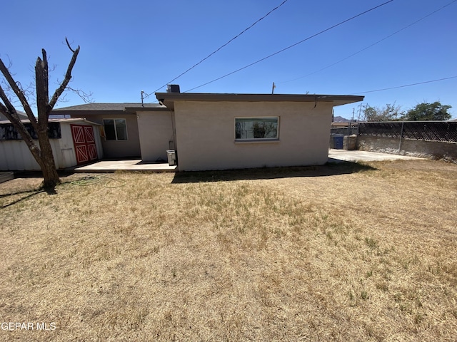 10356 Preston Dr, El Paso, TX 79924 - rear view of house with stucco siding and a storage shed