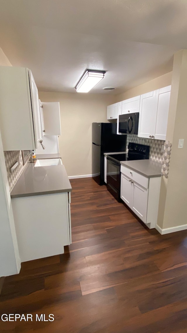 10356 Preston Dr, El Paso, TX 79924 - kitchen featuring black appliances, decorative backsplash, dark wood-type flooring, and white cabinets