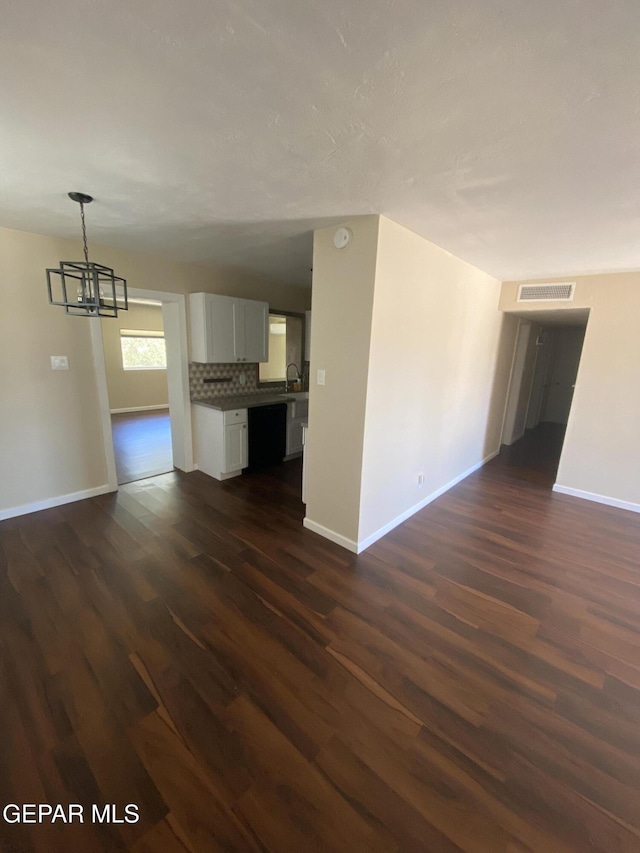 10356 Preston Dr, El Paso, TX 79924 - unfurnished living room with a chandelier and dark wood-style floors