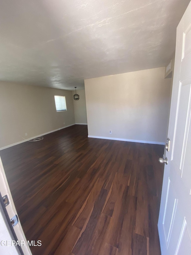10356 Preston Dr, El Paso, TX 79924 - empty room with dark wood-style floors and baseboards