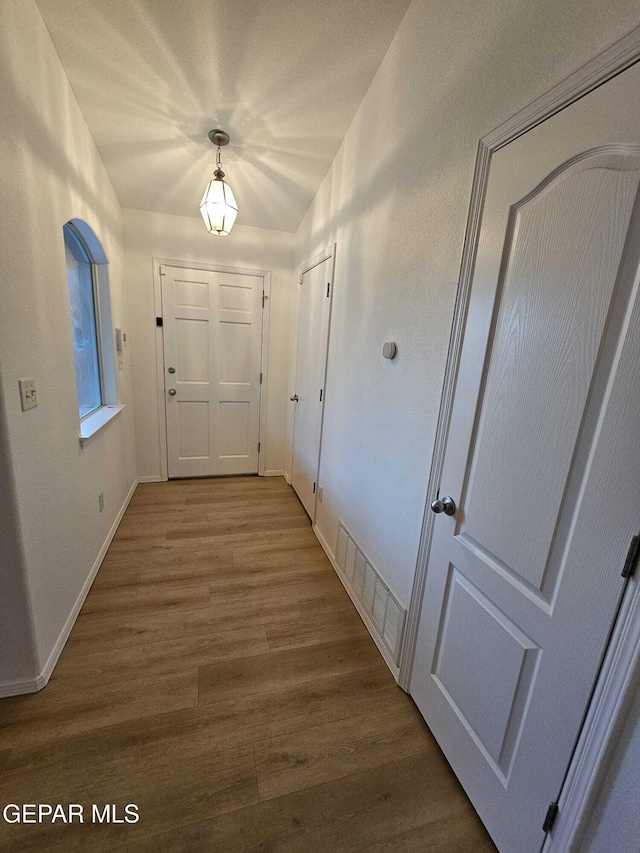 14161 Honey Point Dr, El Paso, TX 79938 - hallway with wood finished floors and baseboards