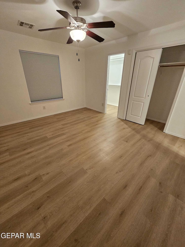 14161 Honey Point Dr, El Paso, TX 79938 - unfurnished bedroom with light wood finished floors, a closet, and ceiling fan