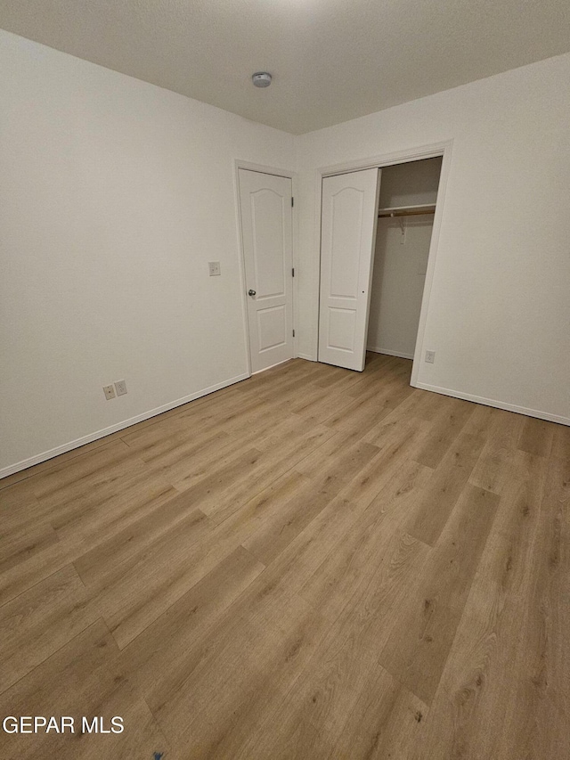 14161 Honey Point Dr, El Paso, TX 79938 - unfurnished bedroom featuring wood finished floors and a closet